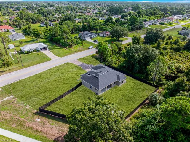 Single-story residence featuring a dark shingle roof and a fenced perimeter