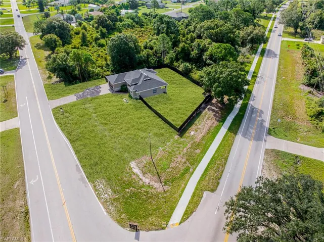 Single-story residence featuring a dark shingle roof, attached two-car garage, and a fenced backyard