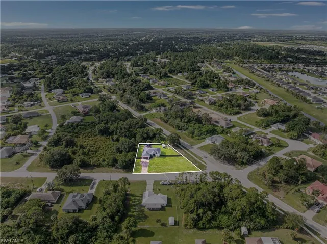 Aerial perspective showcasing a residential property with a green lawn
