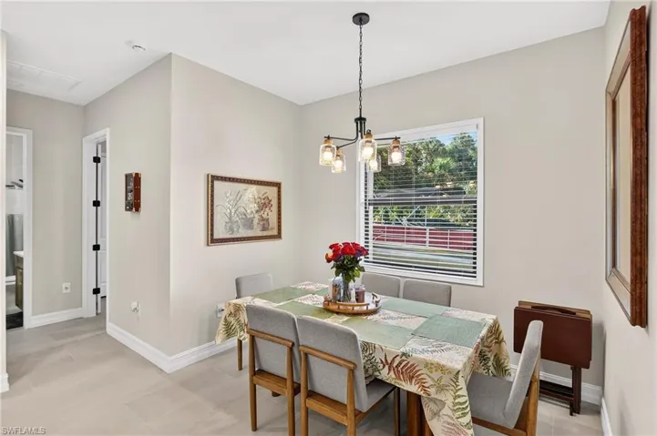 Recessed lighting, wood-finish flooring, and a modern ceiling fixture illuminate this space