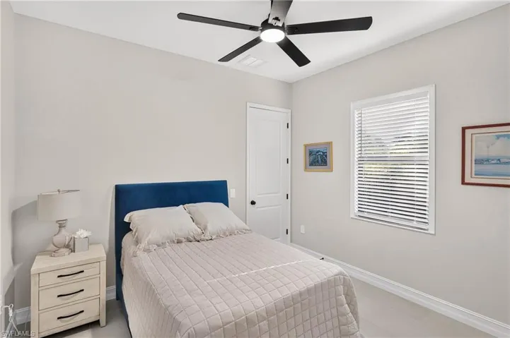 Recessed lighting with a ceiling fan, light-toned walls, and a window with blinds