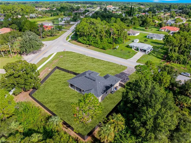 Single-story residence featuring a dark shingle roof, neutral exterior finish, and covered rear patio