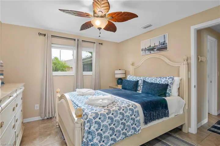 Bedroom featuring a ceiling fan and baseboards