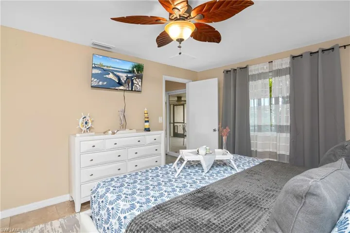 Bedroom featuring ceiling fan and light tile patterned flooring