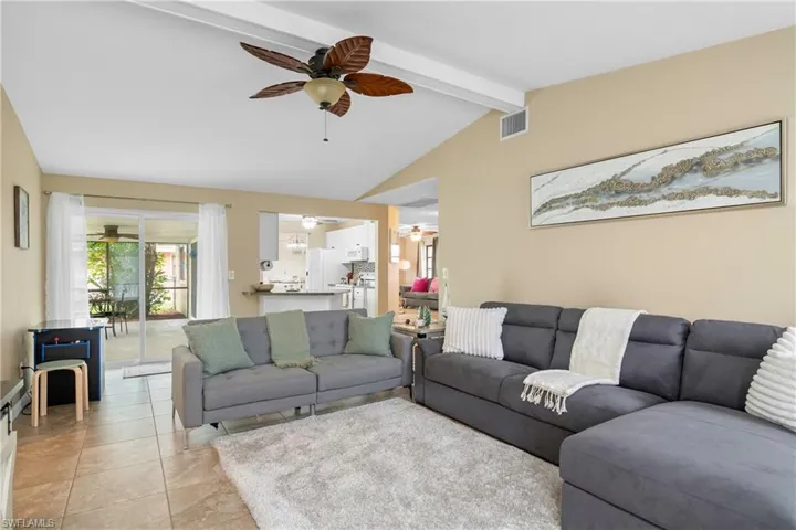 Tiled living area featuring ceiling fan