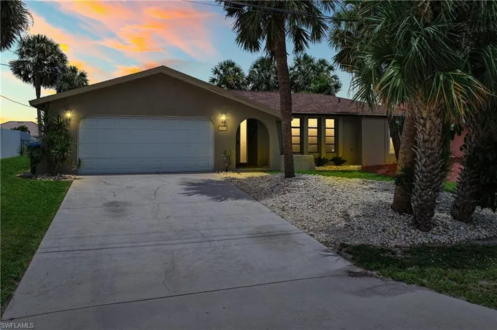 Ranch-style home featuring stucco siding, concrete driveway, and a garage