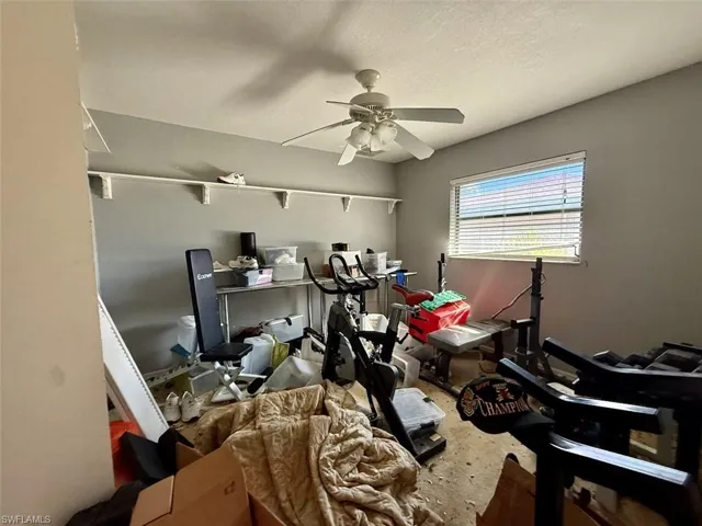 Home office featuring ceiling fan and a textured ceiling
