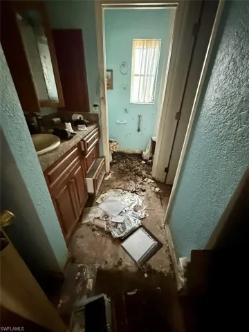 Bathroom featuring vanity and a textured wall