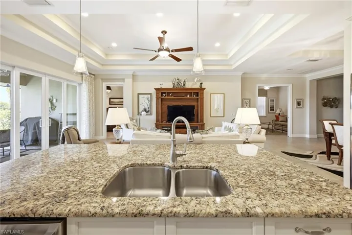 Spacious kitchen island featuring a double stainless steel sink and a gooseneck faucet