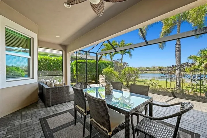 Screened lanai featuring paver flooring, a ceiling fan, and recessed lighting