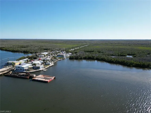 Aerial view of a nearby body of water and a heavily wooded area