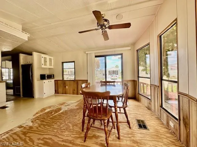 Dining space with ceiling fan and lofted ceiling