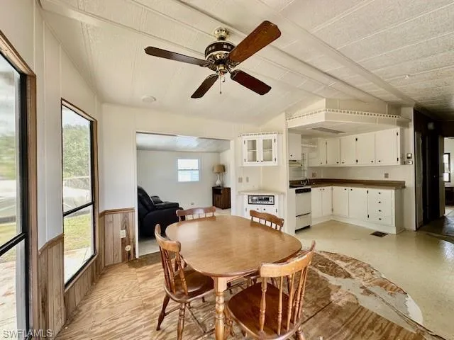 Dining room featuring ceiling fan and lofted ceiling