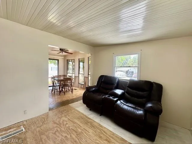 Living room featuring ceiling fan and a wealth of natural light