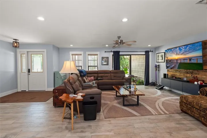 Living area featuring light wood-style flooring, recessed lighting, and a ceiling fan
