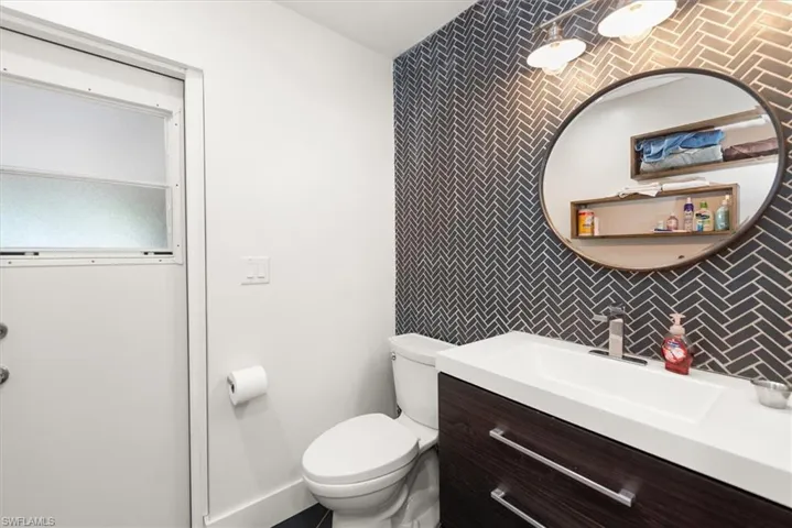 Bathroom featuring vanity and an accent wall