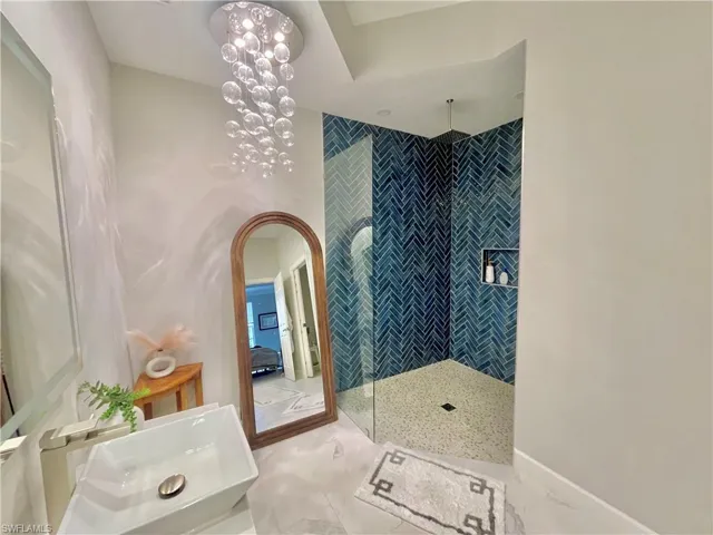 Bathroom with walk in shower, light tile patterned floors, and ensuite bath