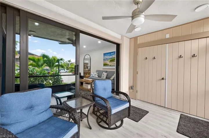 Living area with light wood-style flooring, a ceiling fan, and recessed lighting