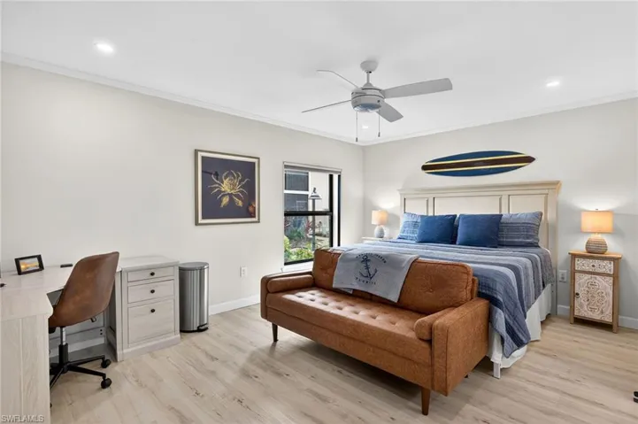 Primary Bedroom with ornamental molding, light wood-style flooring, ceiling fan, an office area, and recessed lighting