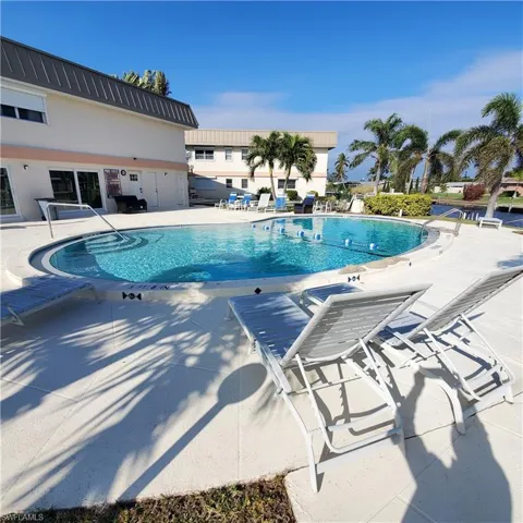 Community pool featuring a patio
