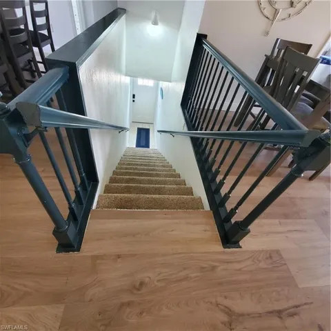 Stairs featuring wood finished floors
