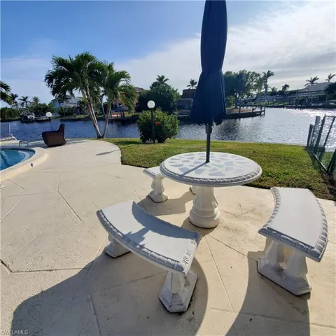 View of patio / terrace with a water view and a dock