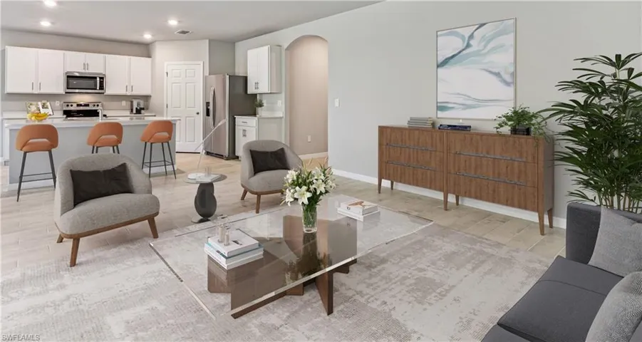 This home is virtually staged. Living area with arched walkways, recessed lighting, and light wood finished floors