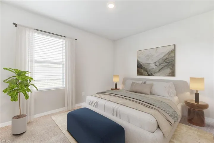 This home is virtually staged. Bedroom with carpet flooring and baseboards