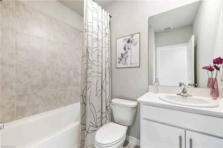 This home is virtually staged. Bathroom with vanity and shower / bath combo