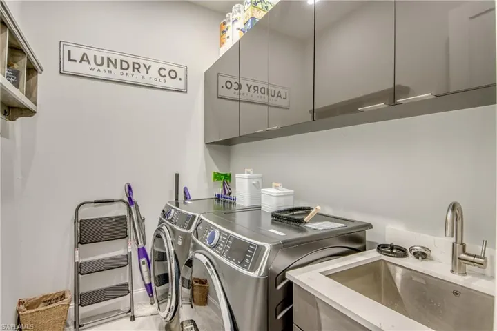 Laundry room featuring a sink and separate washer and dryer