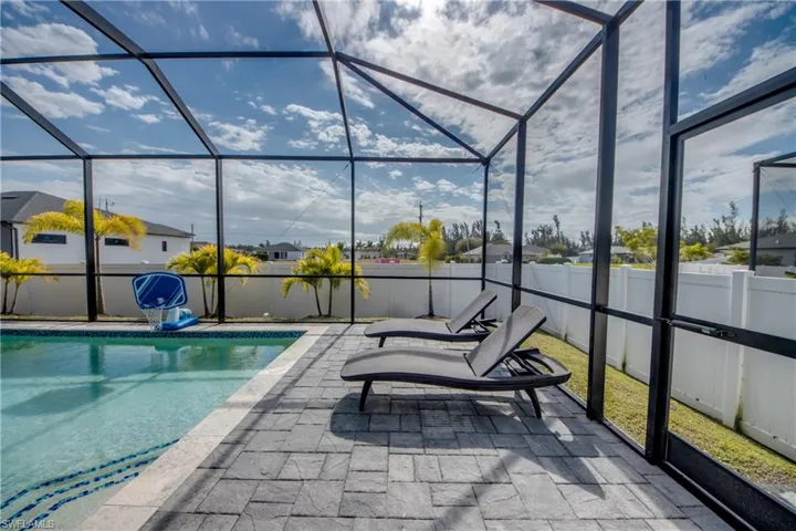 View of pool with a sunroom and a lanai
