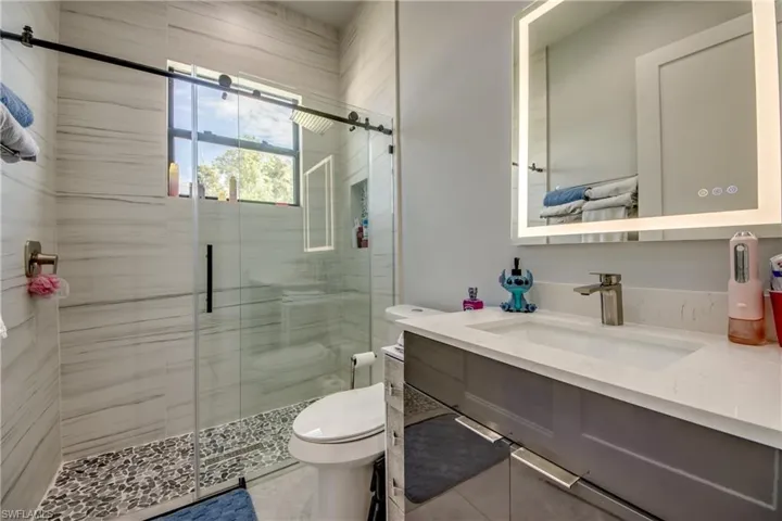 Bathroom featuring vanity and a shower stall