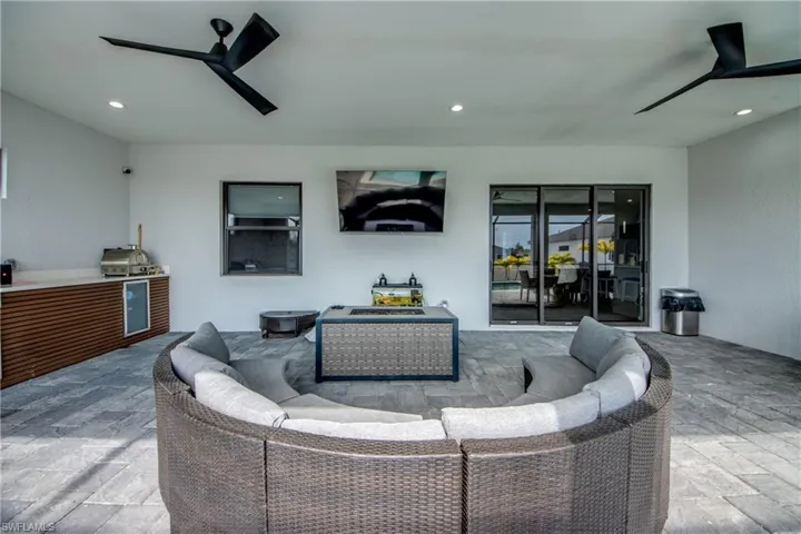 View of patio / terrace with ceiling fan, exterior kitchen, outdoor lounge area, and wine cooler