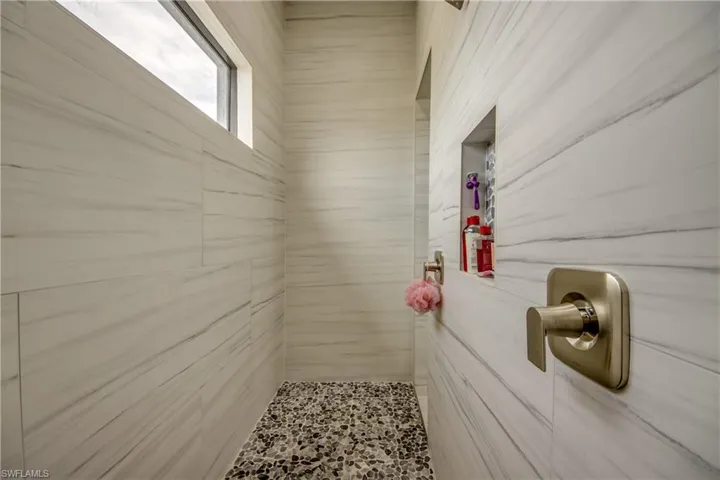 Bathroom featuring tiled shower