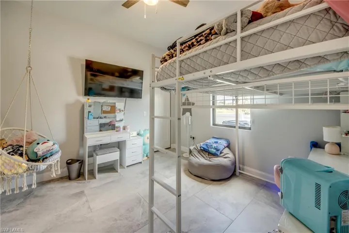 Bedroom featuring an office area and ceiling fan