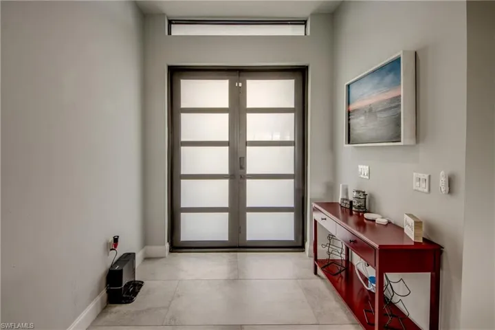 Doorway to outside featuring concrete floors and french doors