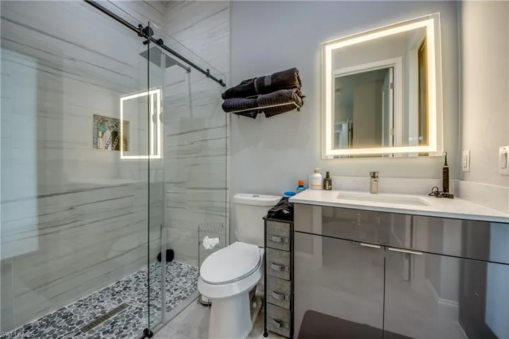 Bathroom featuring vanity and a shower stall