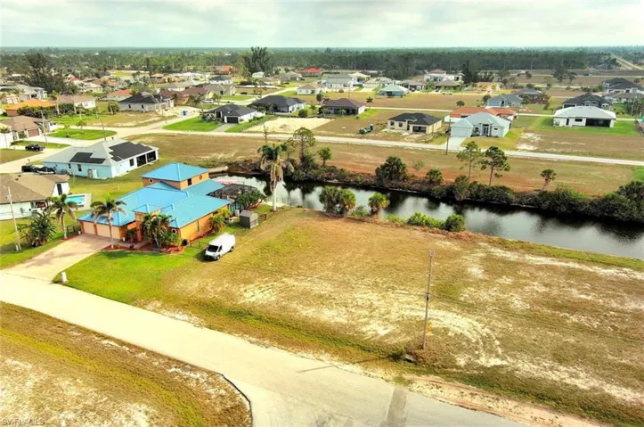 Aerial perspective of suburban area with a nearby body of water