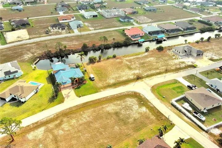 Aerial view of residential area featuring a large body of water