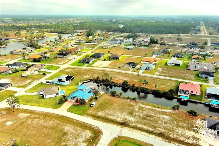 Aerial perspective of suburban area with a nearby body of water