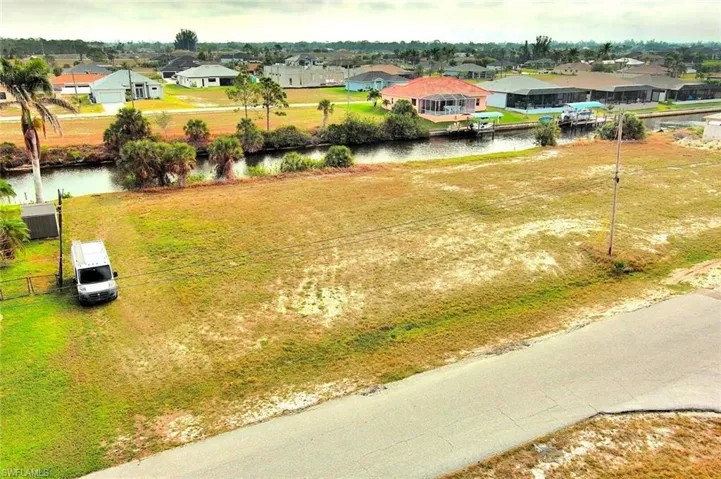 Aerial perspective of suburban area with a nearby body of water