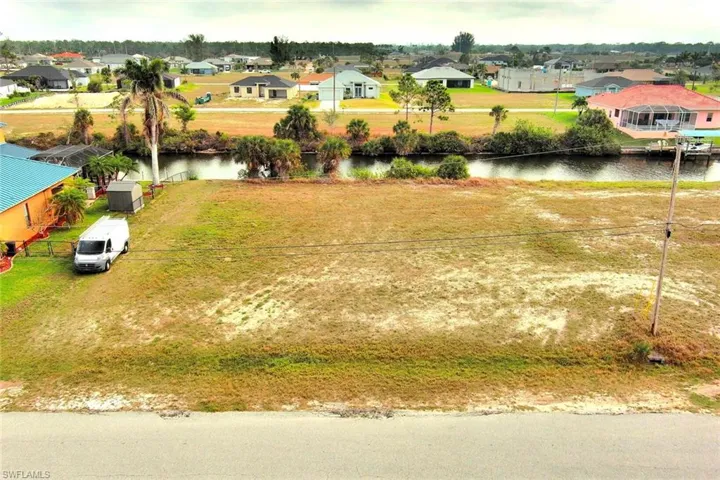Aerial view of residential area featuring a nearby body of water