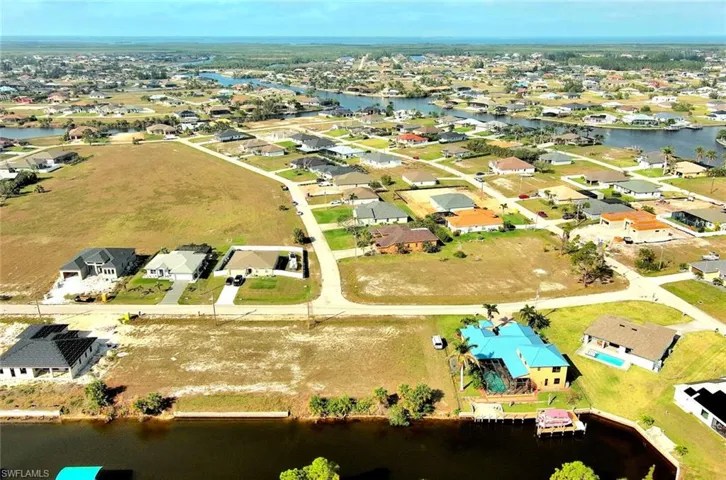 Aerial overview of property's location with a large body of water and nearby suburban area