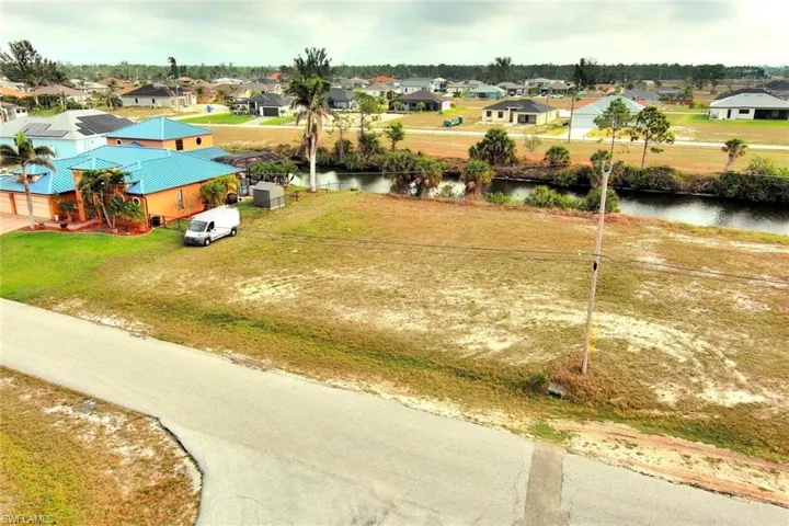 Aerial view of residential area featuring a large body of water