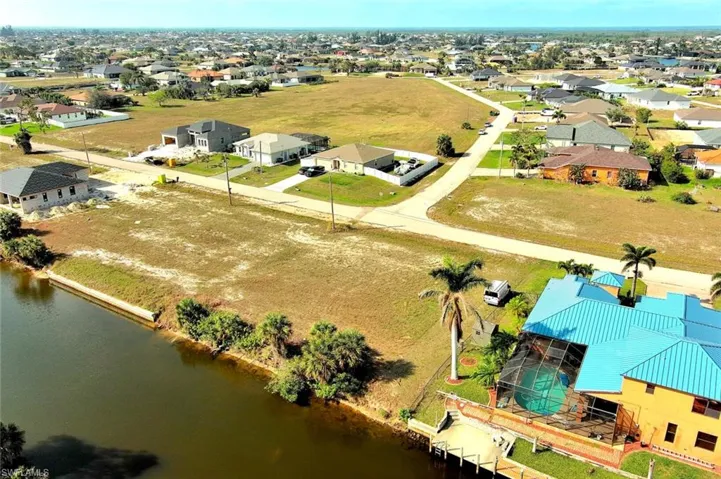 Aerial view of residential area featuring a large body of water