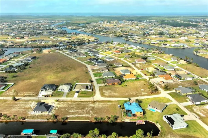 Aerial overview of property's location featuring a large body of water and nearby suburban area