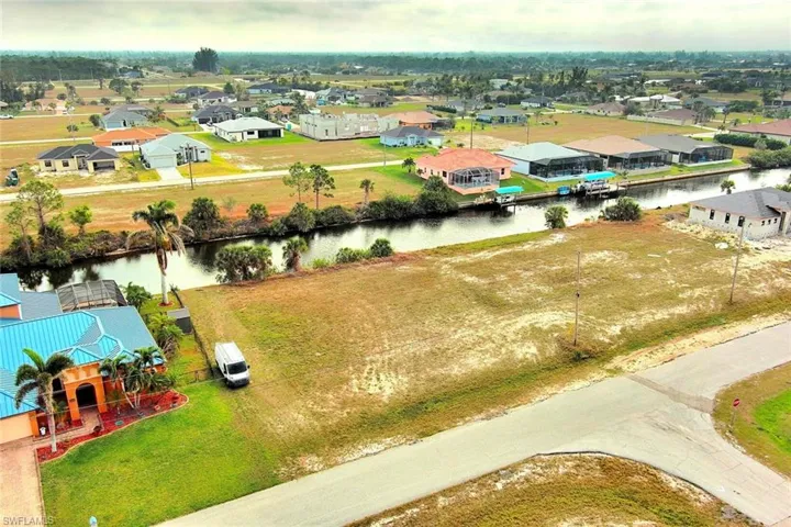 Aerial view of residential area featuring a large body of water