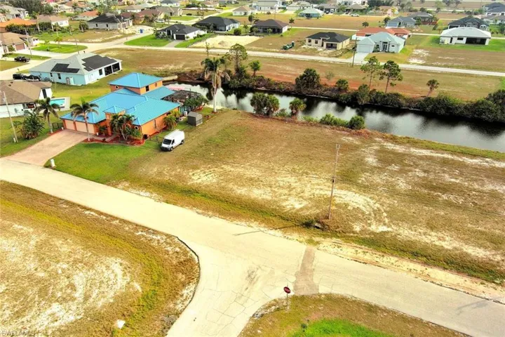 Aerial perspective of suburban area featuring a nearby body of water