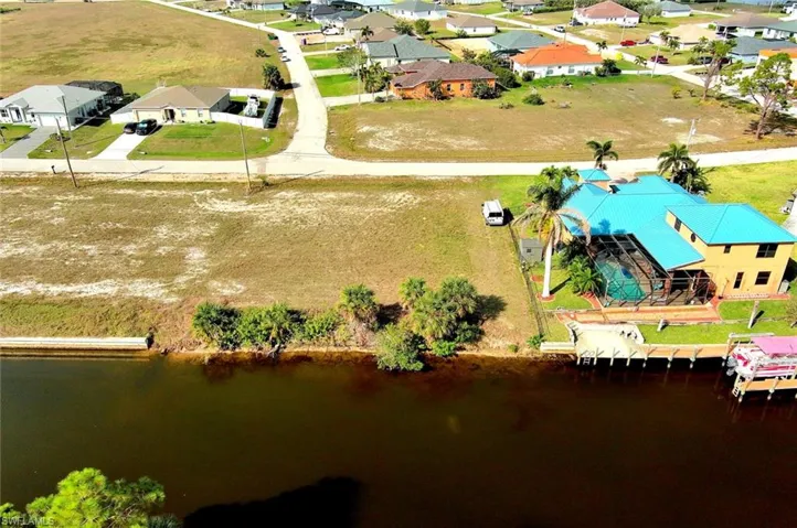 Aerial view of residential area featuring a large body of water