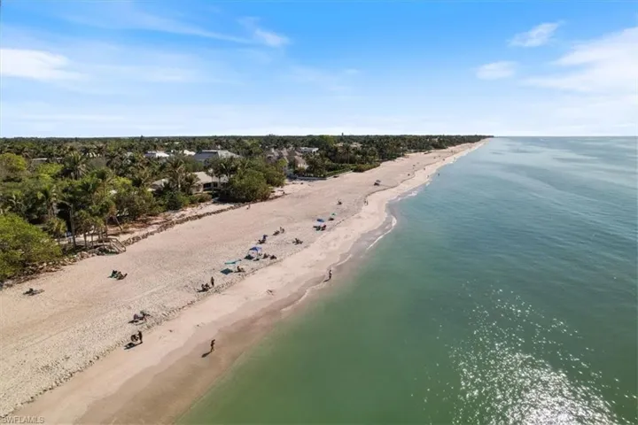 Bird's eye view featuring a water view and a beach view